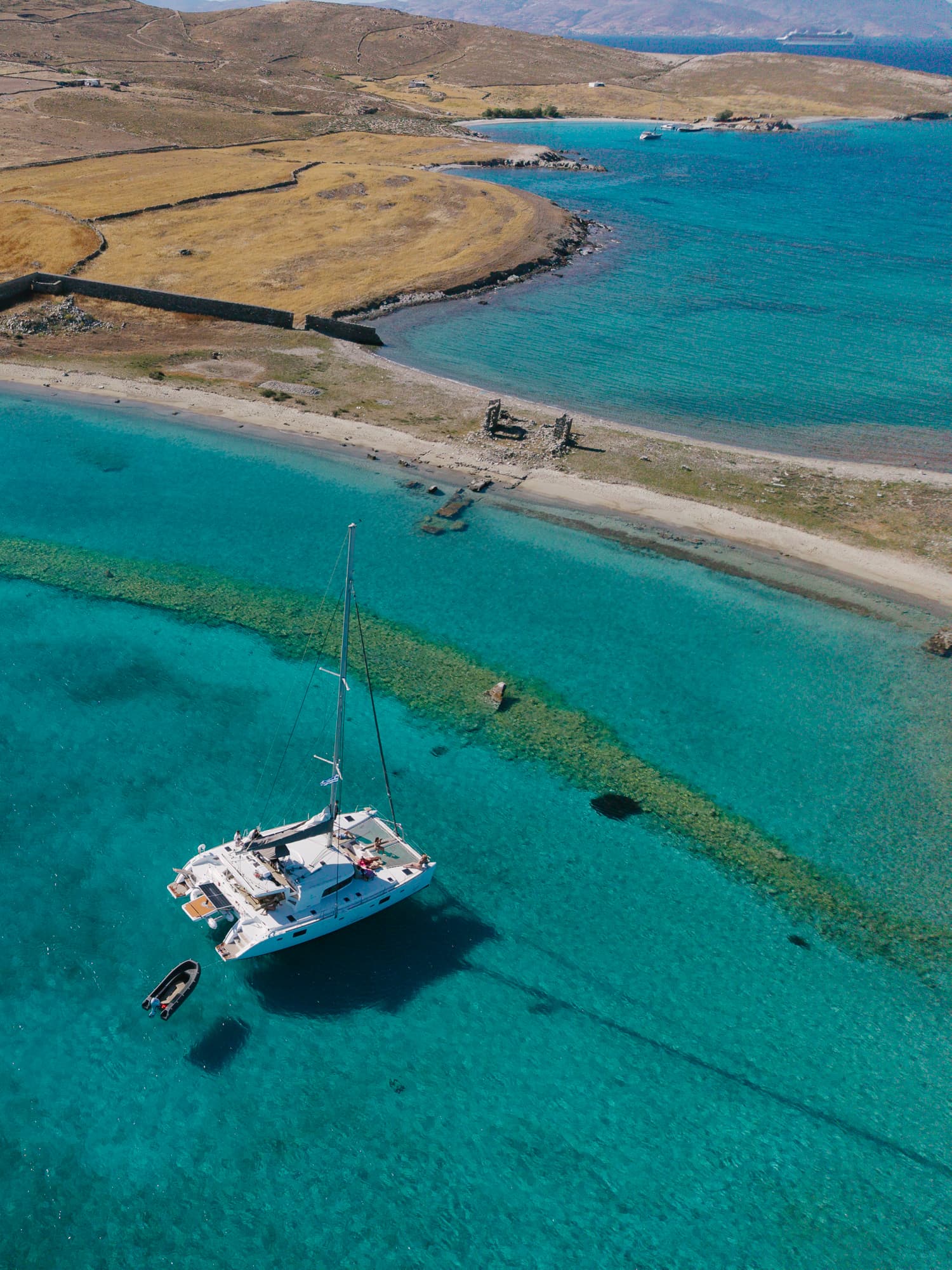 Aerial view of the catamaran off the Delos coastline